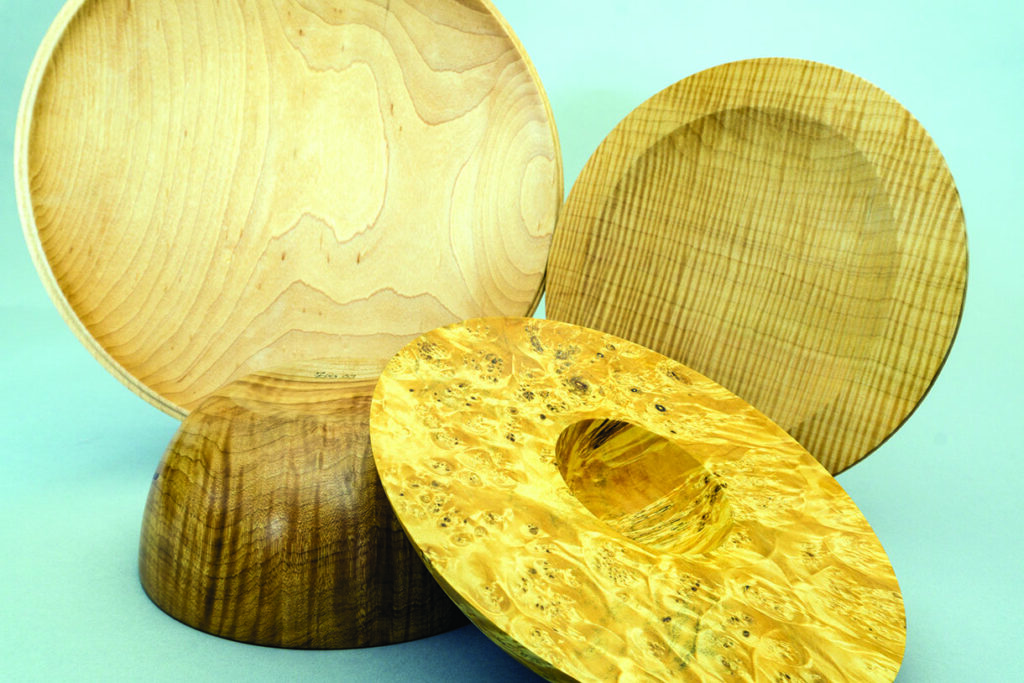 Three wooden bowls with unique grain patterns.