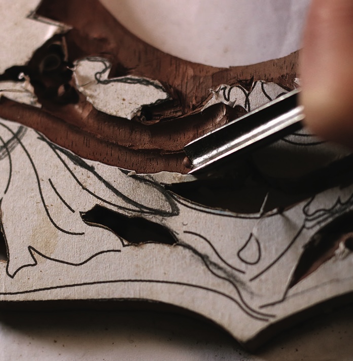 Close-up of intricate wood carving in progress.