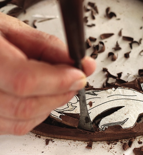Hand carving intricate chocolate design