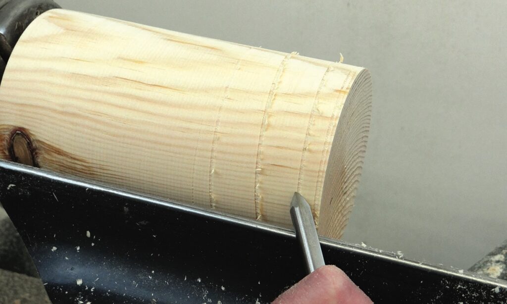 Woodturning with a chisel on a lathe