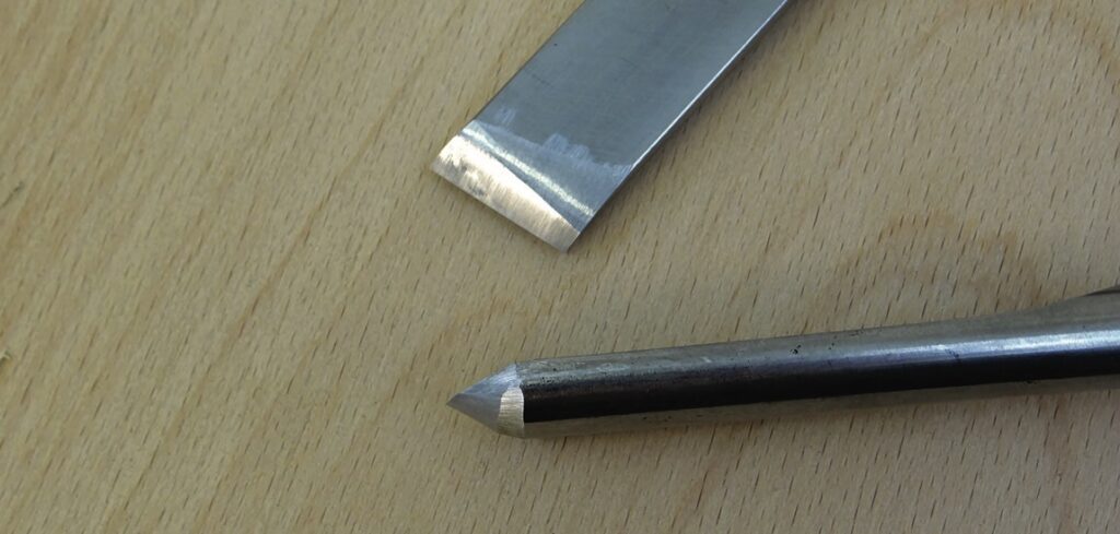 Close-up of metal lathe tools on wood surface.