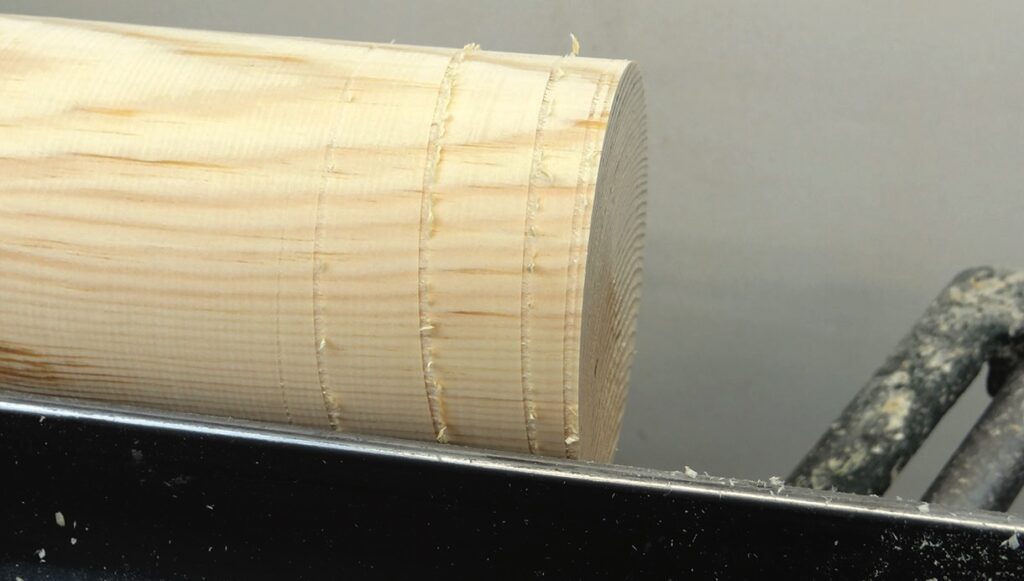 Close-up of a freshly cut wooden dowel.