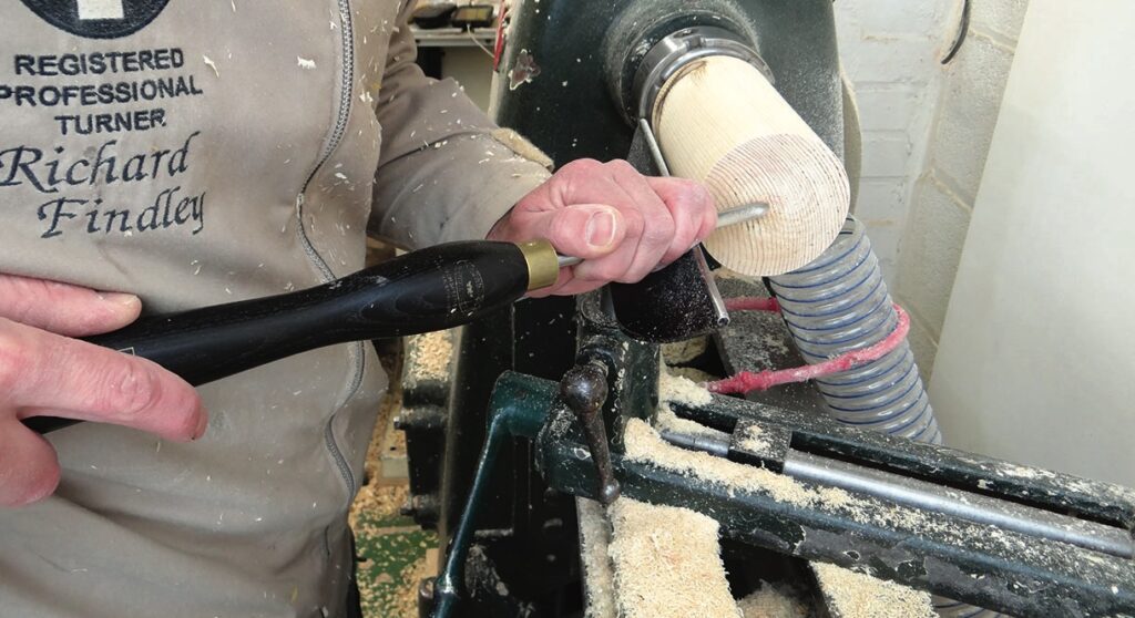 Person using lathe for wood turning project.