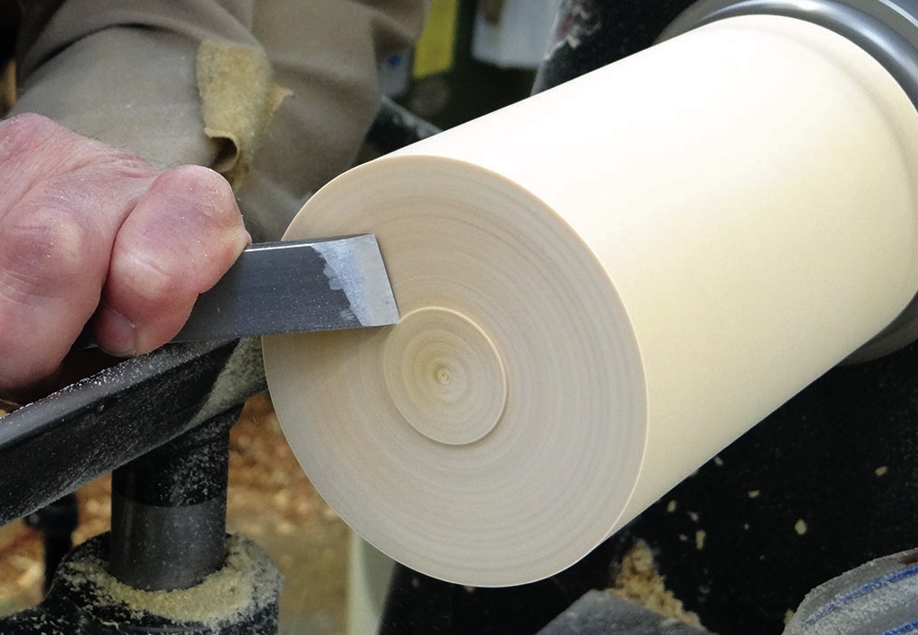Woodturning lathe crafting a cylindrical object