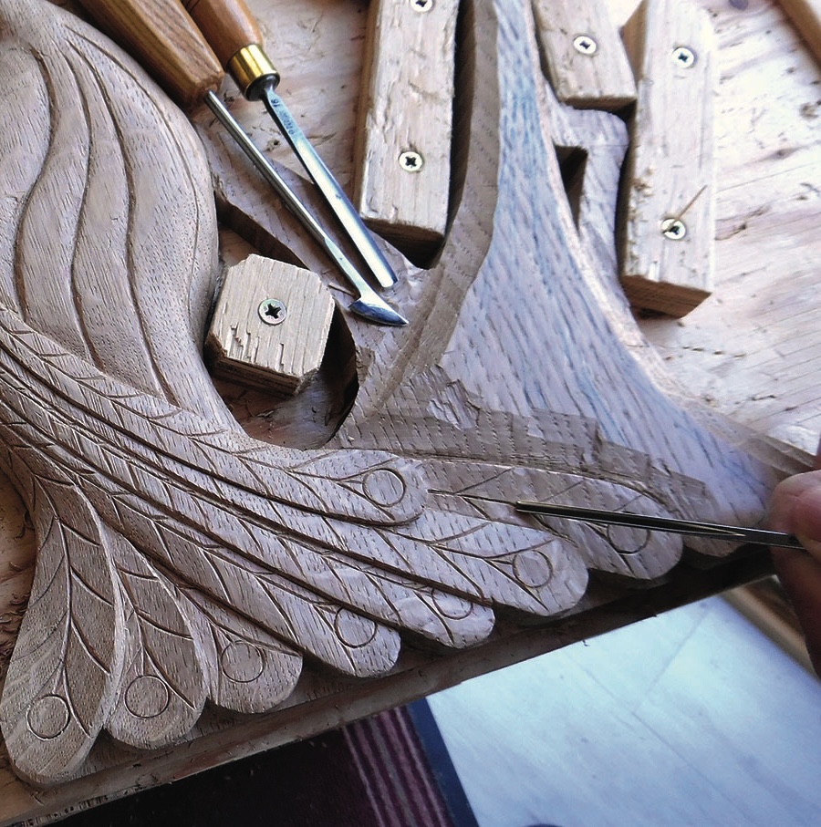 Intricate wood carving with tools on table