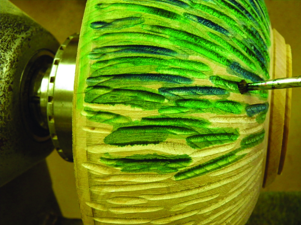 Wood lathe crafting with green paint design