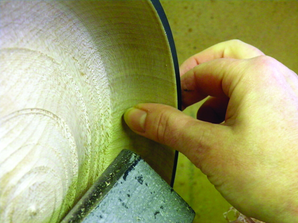 Hand turning wood on a lathe.