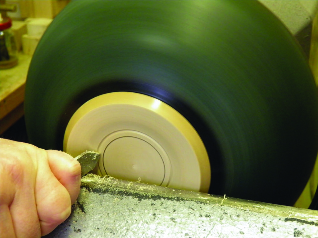 Woodturning on lathe with chisel