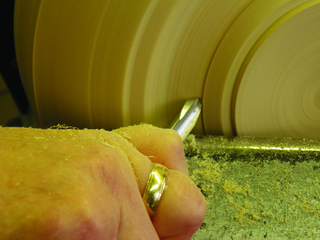 Person using a lathe for woodturning.
