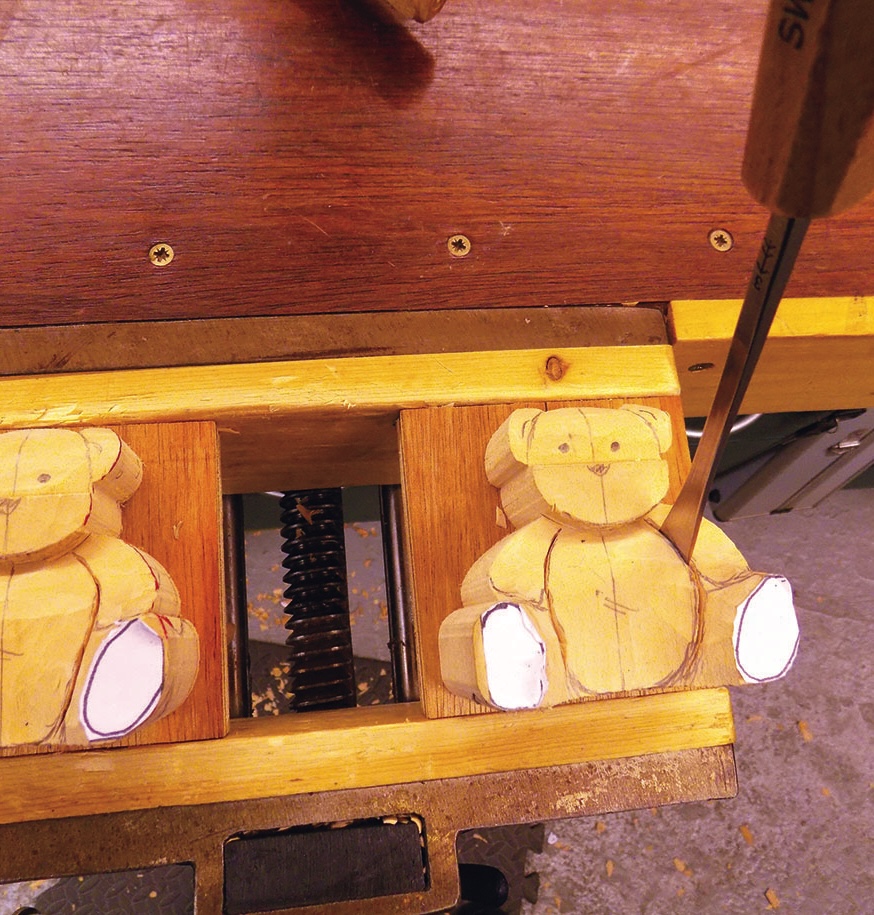 Wooden teddy bear carving in progress.
