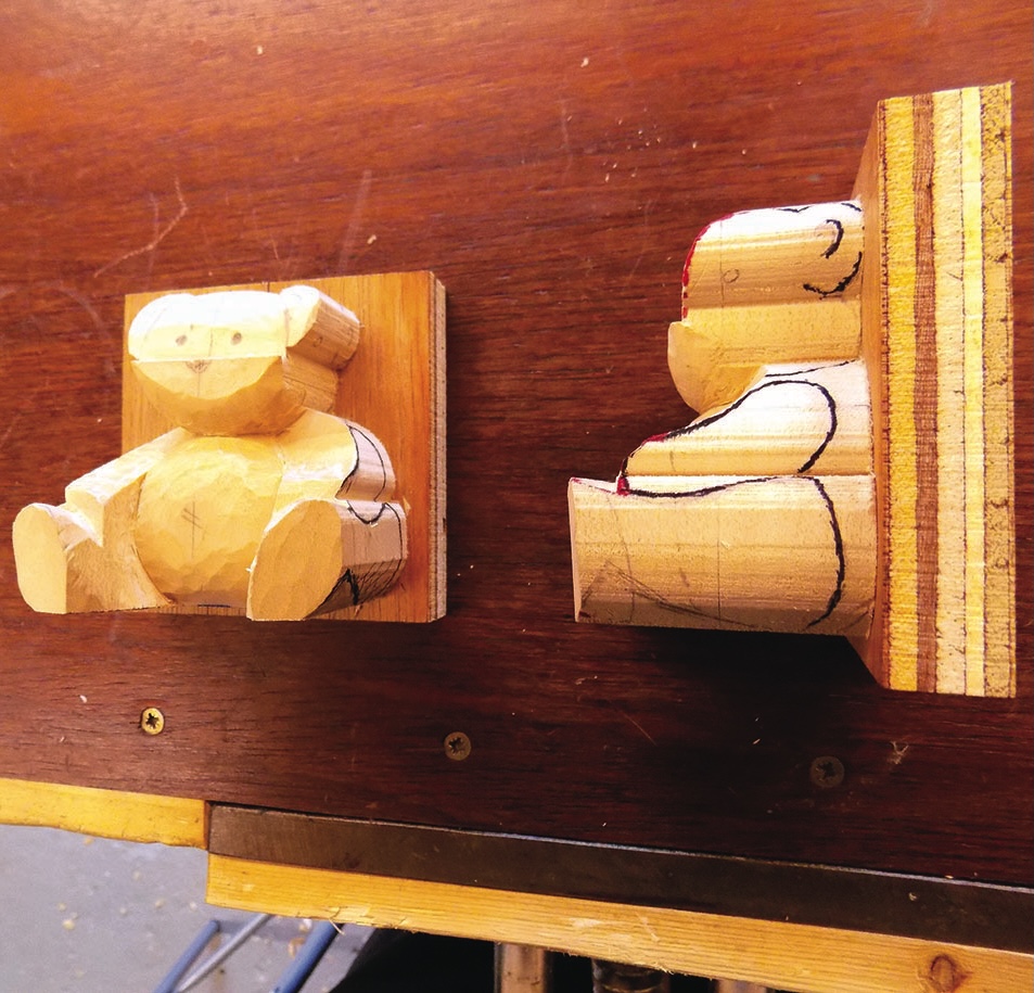 Two wooden bear carvings on a table