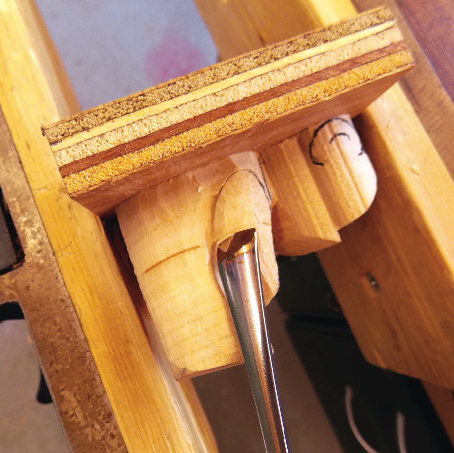 Wood carving vise holding a carved wooden piece.