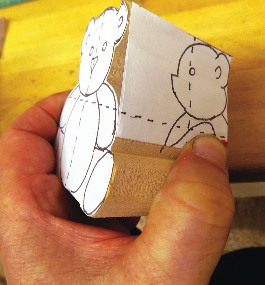 Hand carving teddy bear from wood block template.