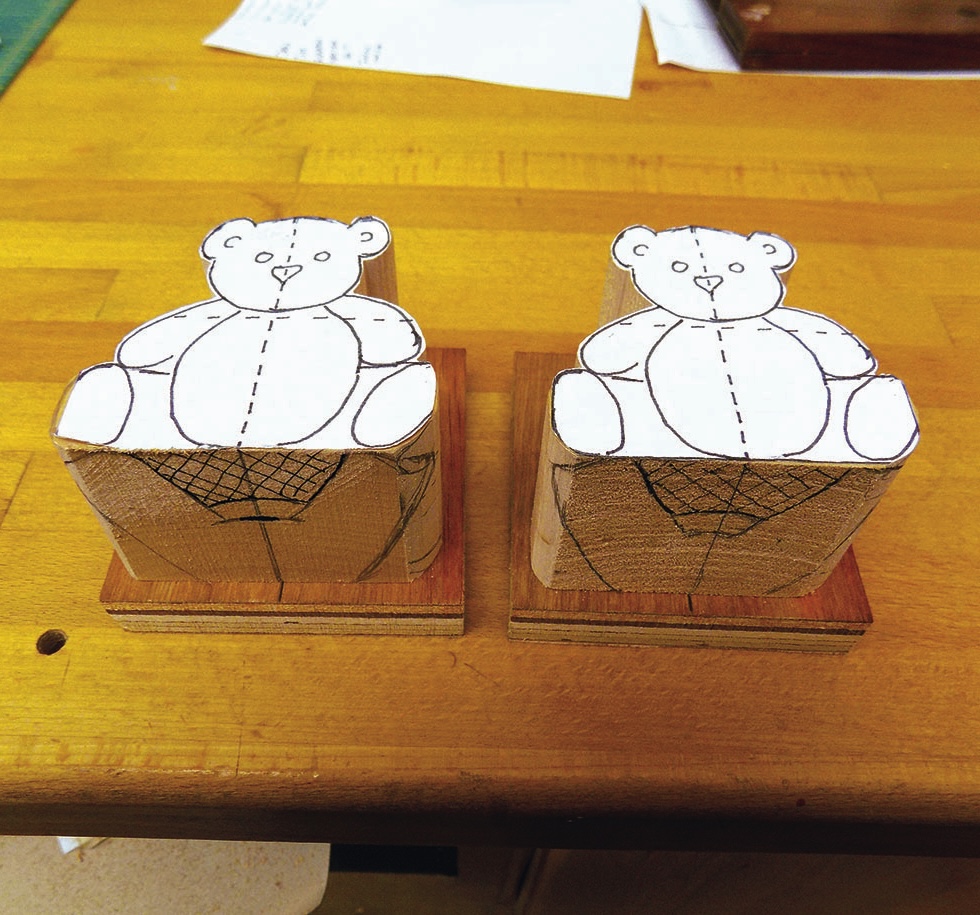 Wooden teddy bear cutouts on wooden bases.
