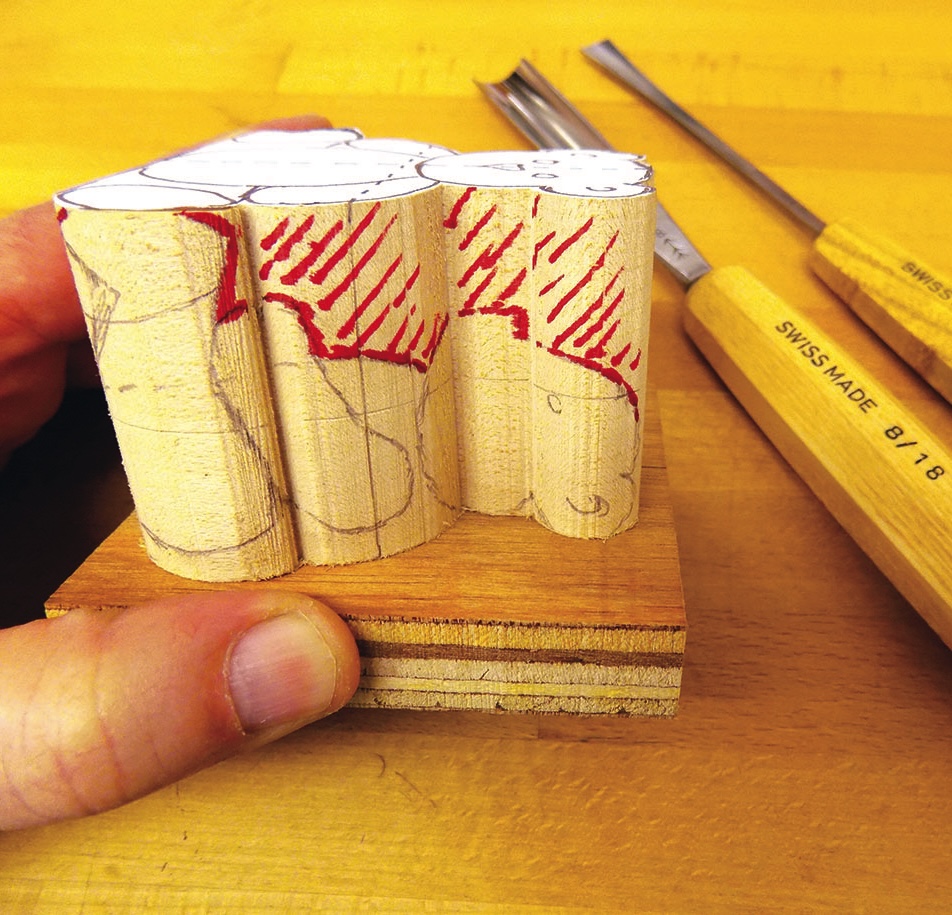 Wood carving block and chisels on table.