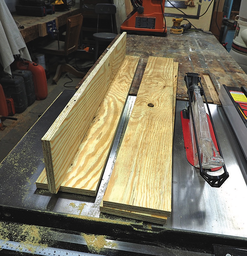 Wood planks on table saw in workshop.