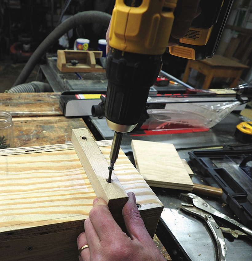 Person using drill on wooden board