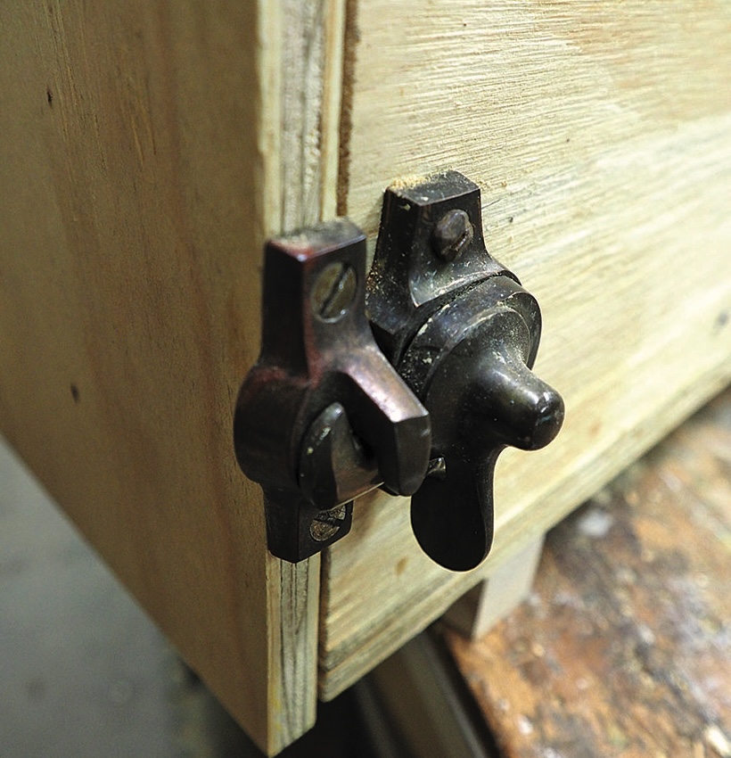 Old latch on wooden door corner