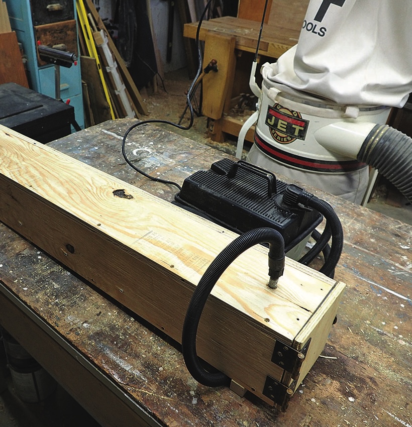 Workshop with dust extractor and wooden equipment.