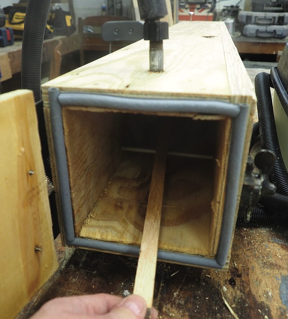 Wooden box clamp in a workshop setting.