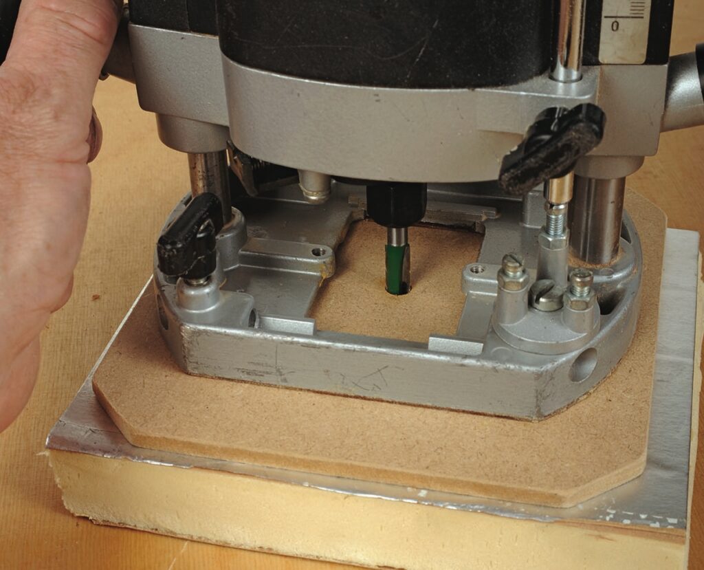 Close-up of a router shaping wood surface.
