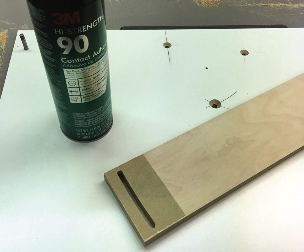 3M adhesive spray and wooden board on table.