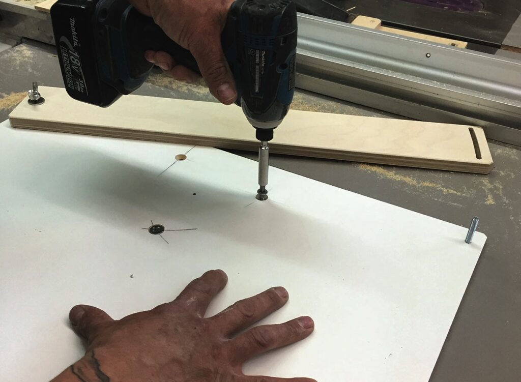 Person using drill on wooden board