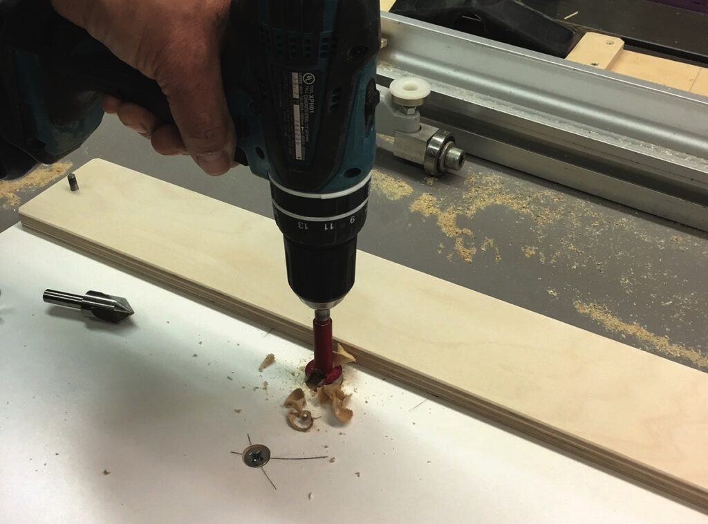Drilling a hole in a white board.