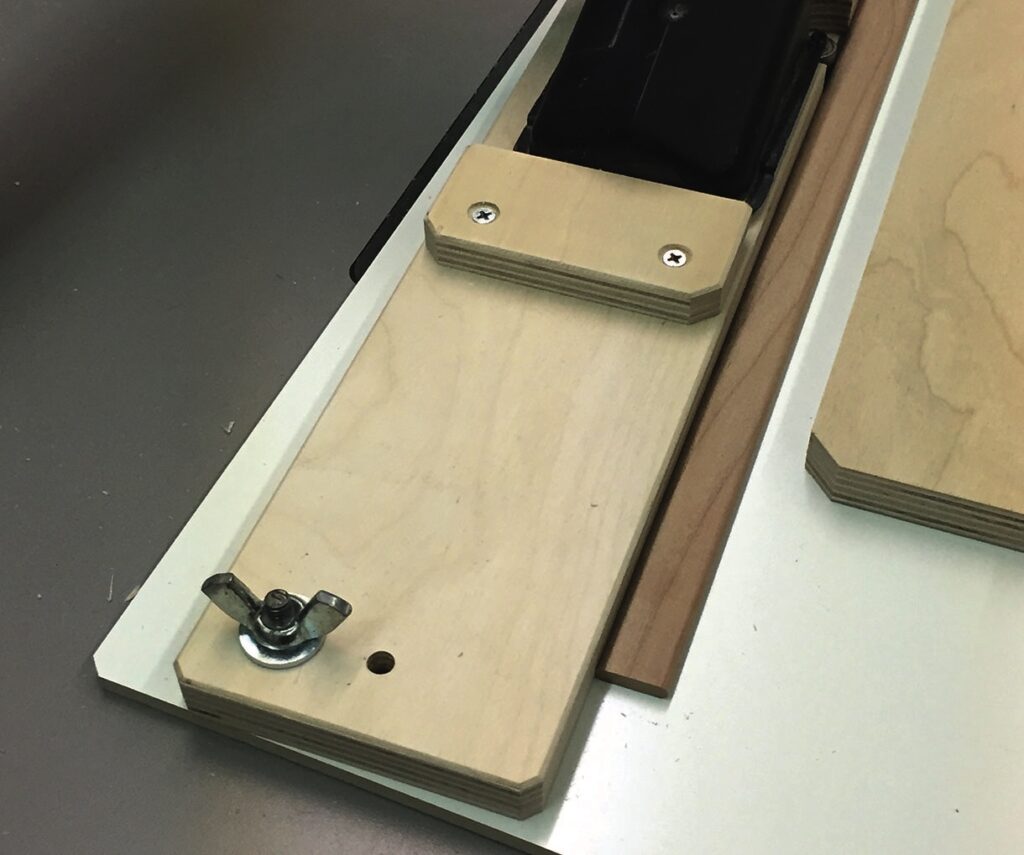 Woodworking jig with wing nut and screws.