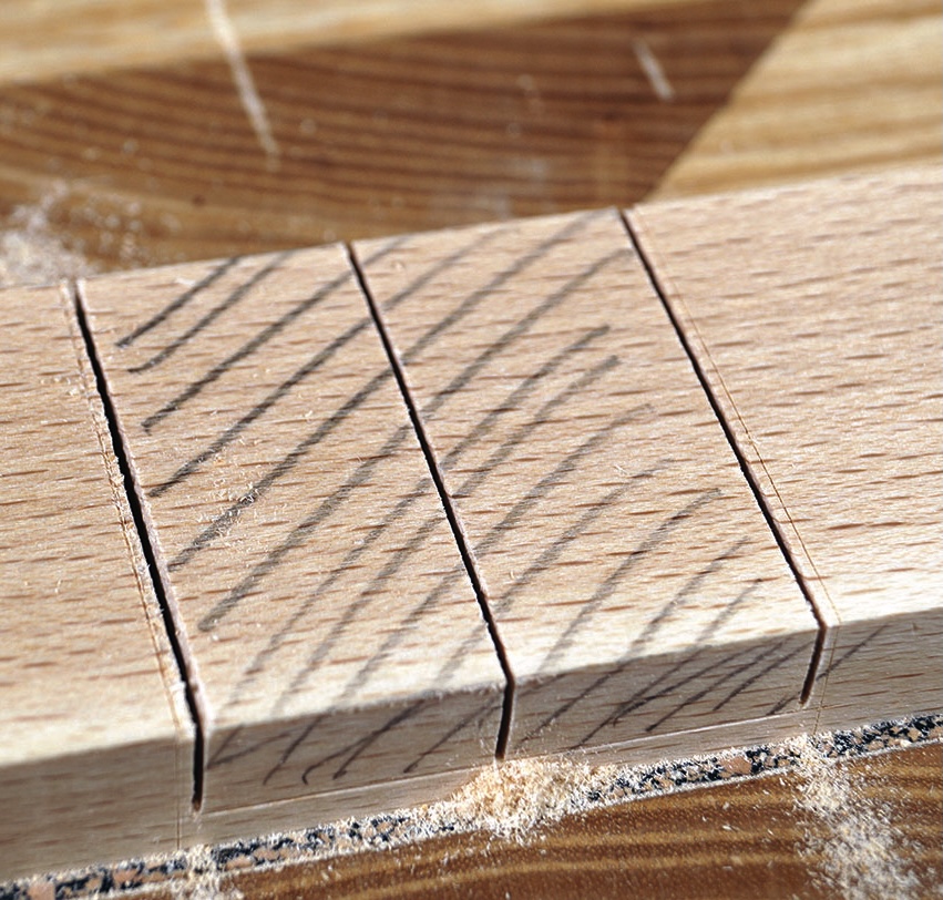 Close-up of wooden plank with pencil markings.