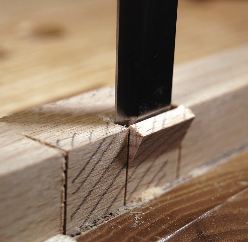 Saw cutting precise dovetail joint in wood