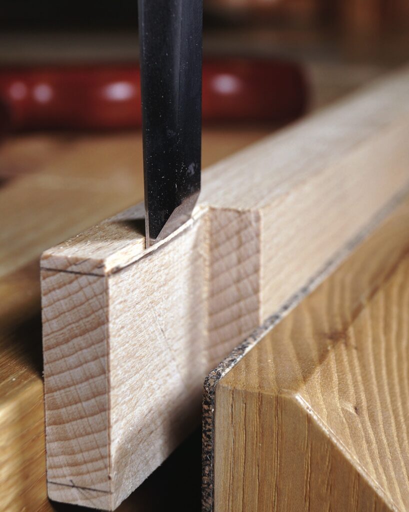Chisel carving a wooden joint