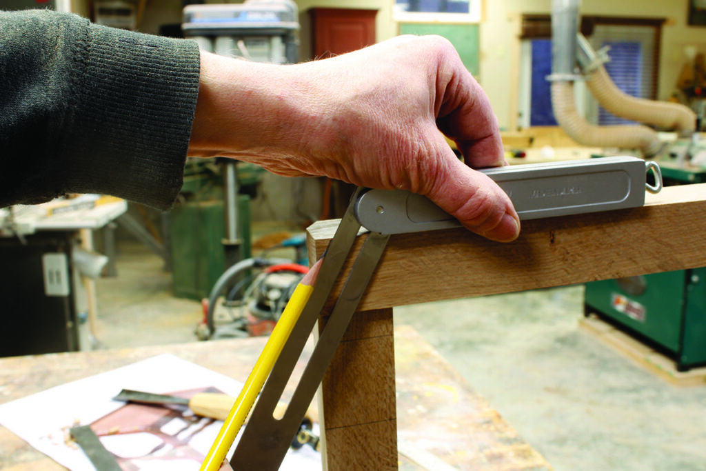 Measuring wood with a precise angle tool.