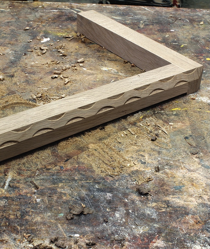 Wood carving on workbench in progress.