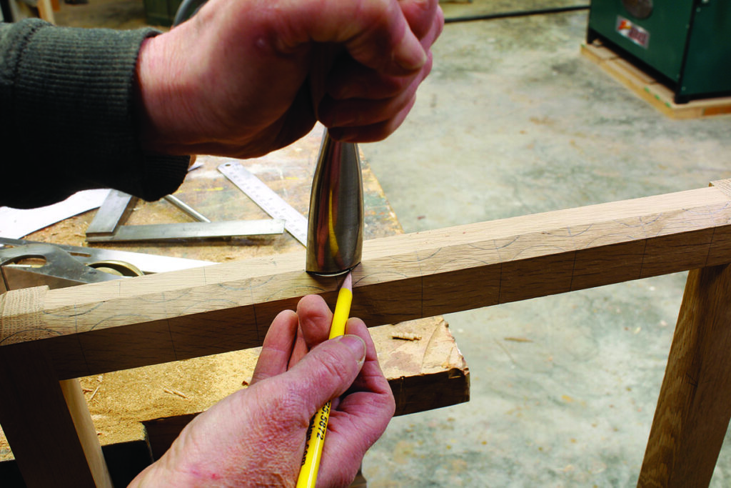 Person marking wood with a gauge tool.