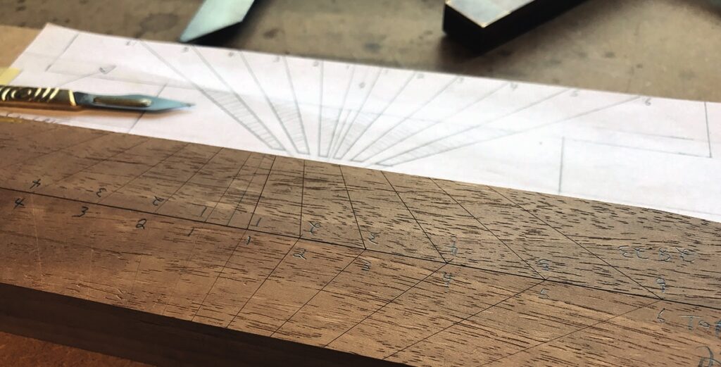 Woodwork project plan with measurements and scalpel.