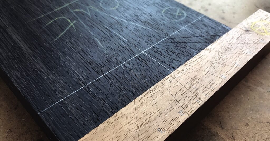 Closeup of precision woodwork project with measured lines.