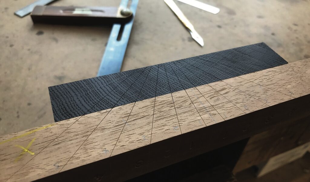 Woodworking tools and wood piece with marked lines.