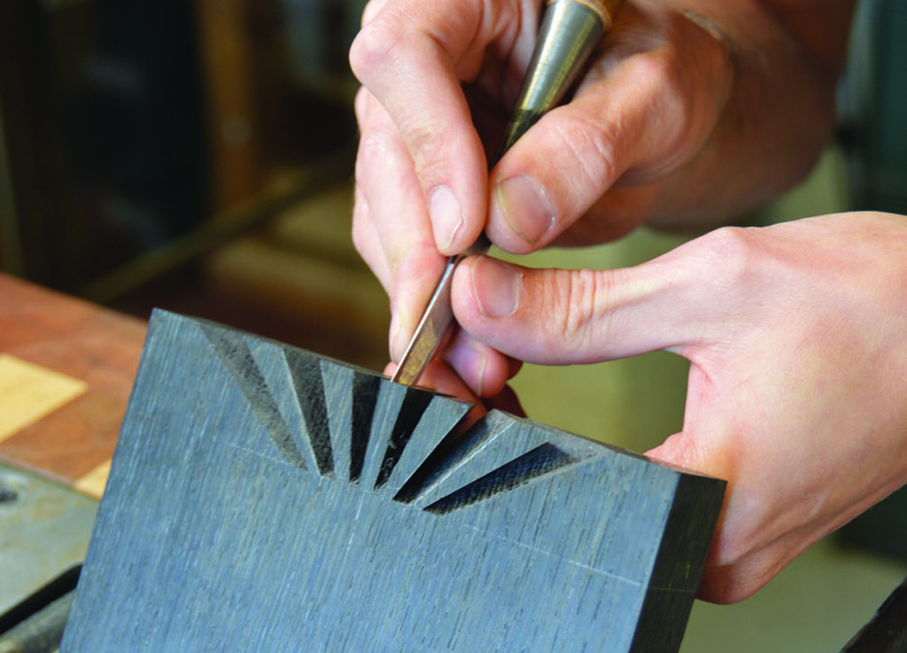 Craftsman chiselling wood with precision.