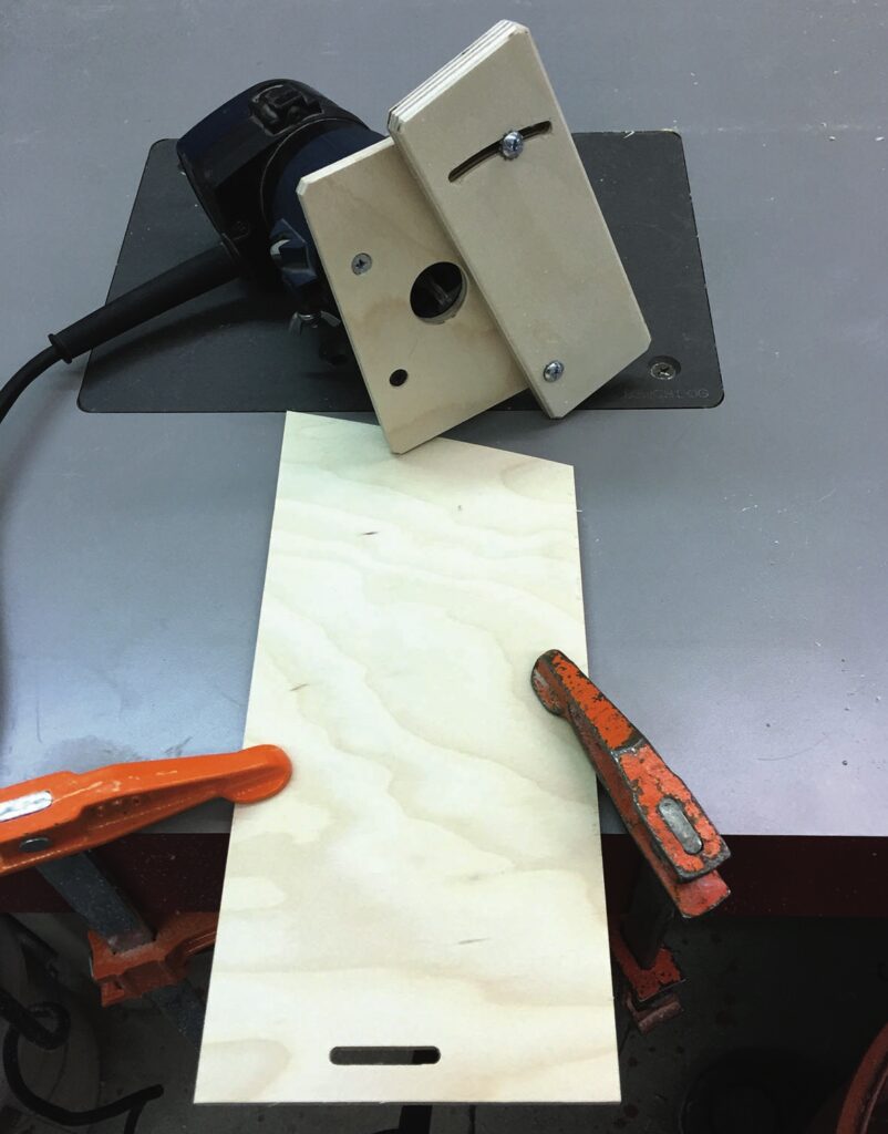 Woodworking setup with router and clamped board.
