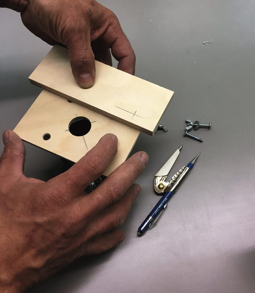 Hands assembling wooden pieces with screws and tools.