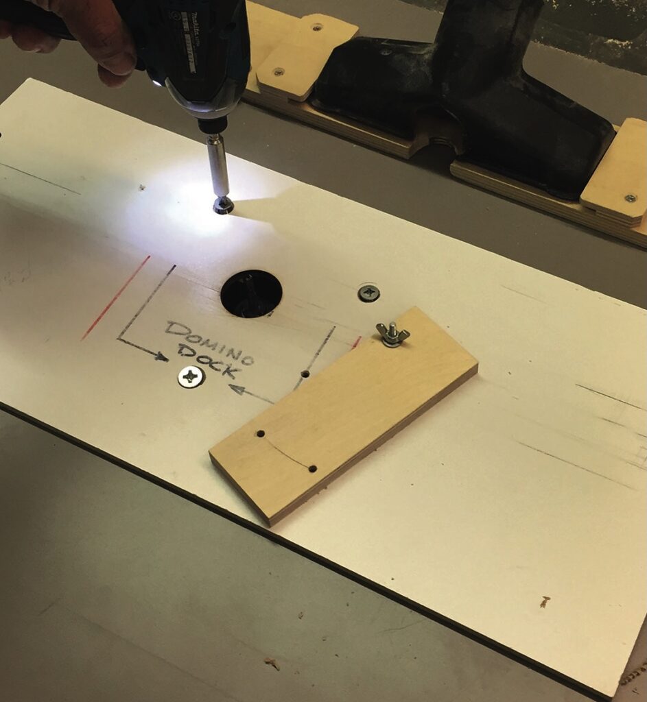 Screwdriver assembling wood piece on workbench.