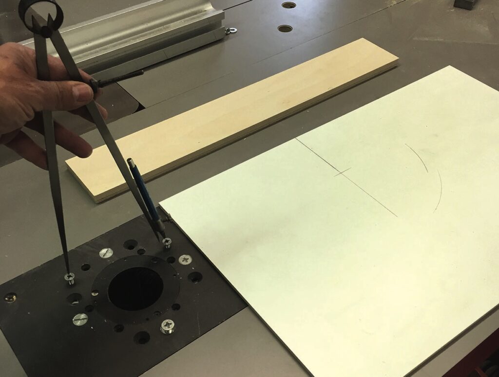 Using compass for woodworking measurements on table saw.