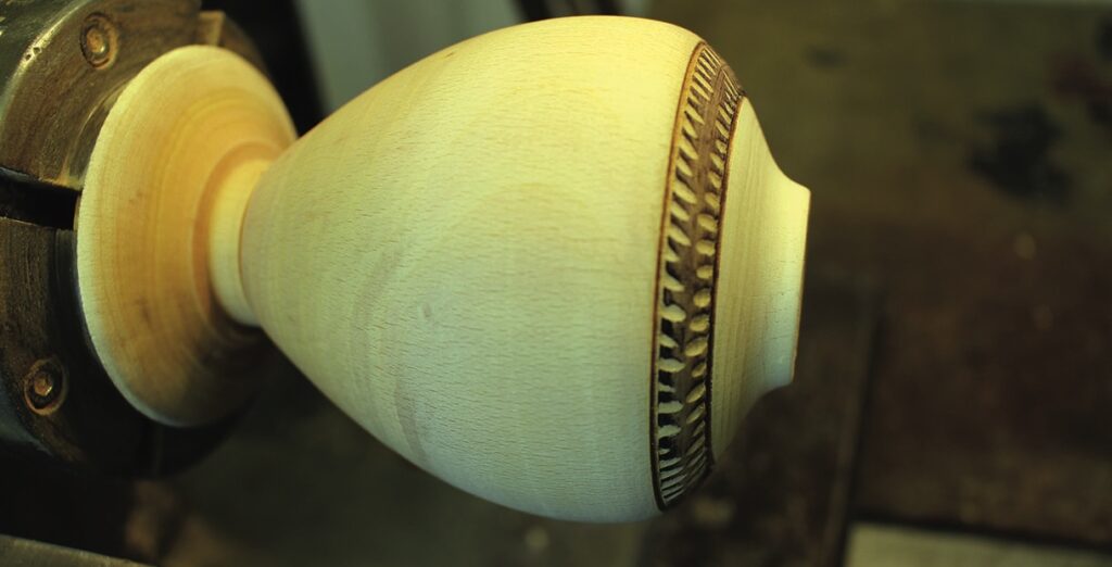 Wood lathe turning intricate vessel design