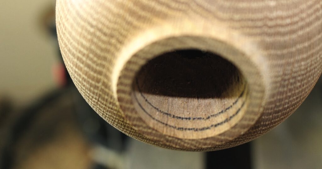Close-up of wooden object with circular opening.
