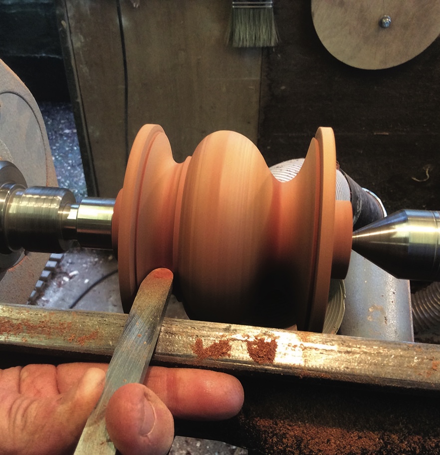 Woodturning on a lathe with shaping tool