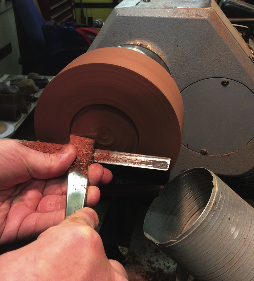 Person using lathe to shape wood.