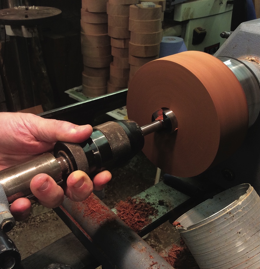Wood lathe turning block, craftsman at work.