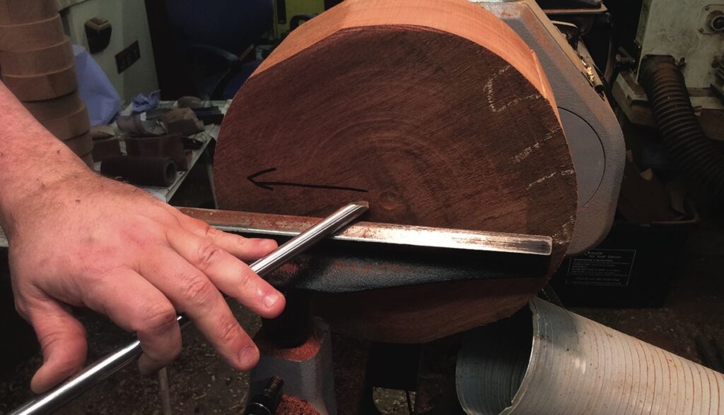 Person using lathe to shape wooden block