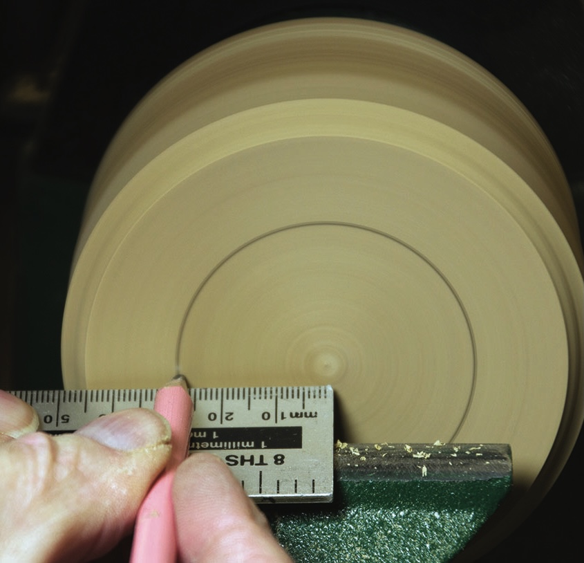 Measuring spinning pottery with ruler